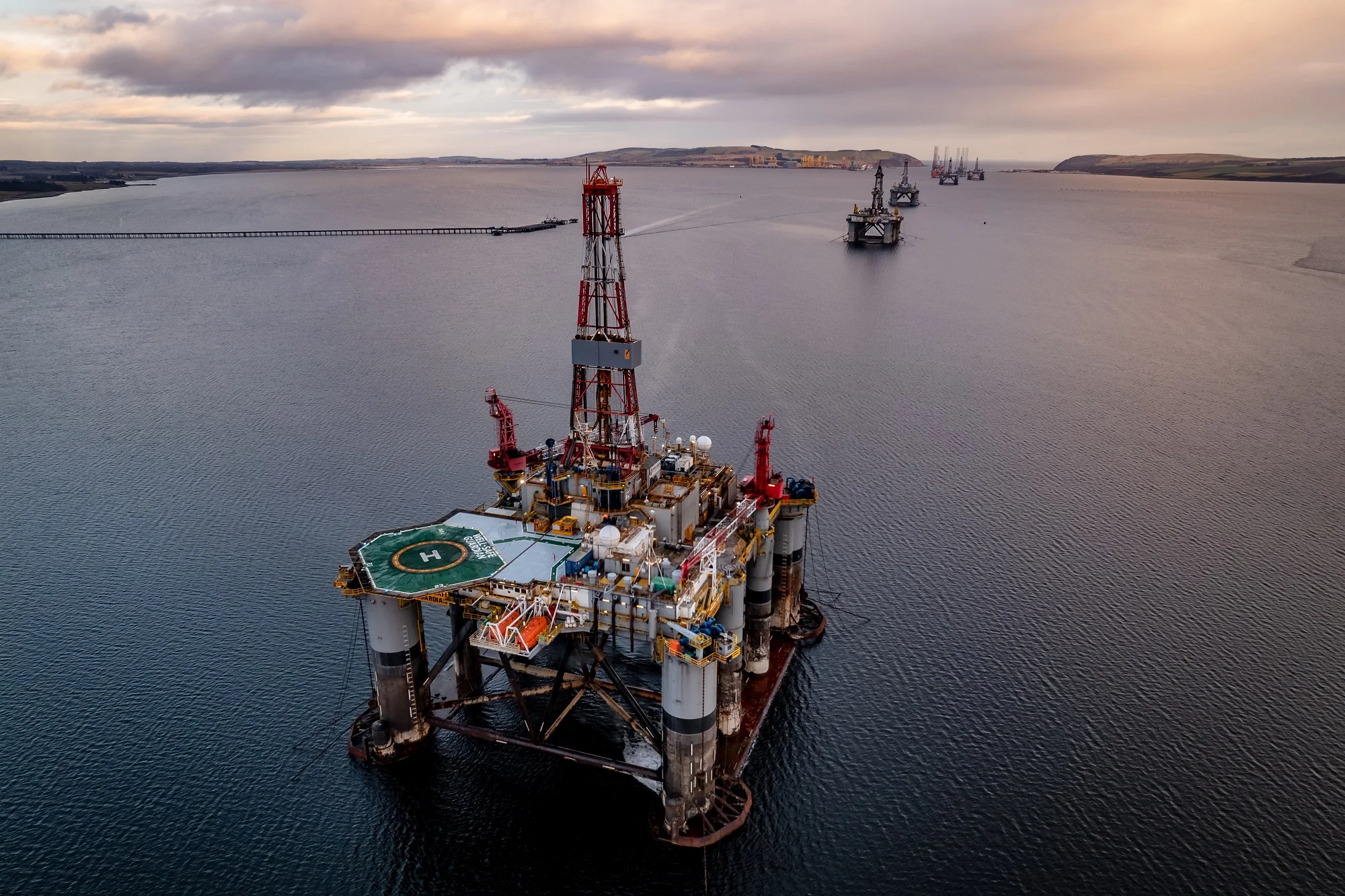oil-and-gas-drilling-platform-at-sea-at-sunset-2024-12-06-23-08-27-utc